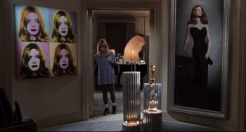 Movie still from “The First Wives Club” (1996), directed by Hugh Wilson – A woman standing in front of a lamp in a room; Wide shot, Over the shoulder angle