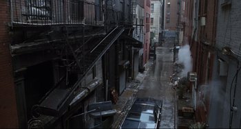 Movie still from “The First Wives Club” (1996), directed by Hugh Wilson – An alley with fire escapes and a fire hydrant on the side of the street; Extreme Wide shot, High angle