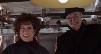 Movie still from “The First Wives Club” (1996), directed by Hugh Wilson – A man and a woman posing for a picture; Medium shot, Low angle