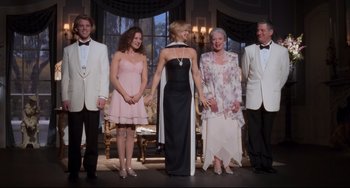 Movie still from “The First Wives Club” (1996), directed by Hugh Wilson – A group of people standing next to each other on a stage; Wide shot, Low angle