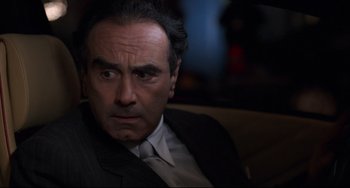 Movie still from “The First Wives Club” (1996), directed by Hugh Wilson – A person wearing a suit and tie; Close Up shot, Over the shoulder angle