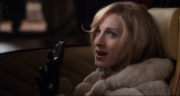 Movie still from “The First Wives Club” (1996), directed by Hugh Wilson – A person in a car wearing a fur coat; Close Up shot, Overhead angle