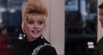 Movie still from “The First Wives Club” (1996), directed by Hugh Wilson – A person wearing a dress; Close Up shot, Over the shoulder angle