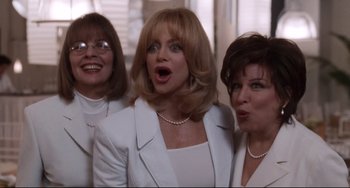 Movie still from “The First Wives Club” (1996), directed by Hugh Wilson – A group of three women standing next to each other; Medium shot, Low angle