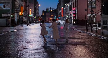 Movie still from “The First Wives Club” (1996), directed by Hugh Wilson – Three women are crossing the street at night; Extreme Wide shot, High angle