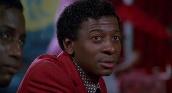 Movie still from “The Five Heartbeats” (1991), directed by Robert Townsend – A person wearing a suit and tie; Close Up shot, Low angle