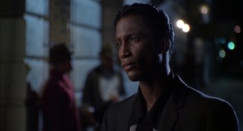 Movie still from “The Five Heartbeats” (1991), directed by Robert Townsend – A man wearing a suit and tie in front of a crowd; Close Up shot, Low angle