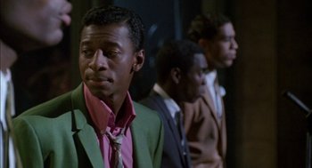 Movie still from “The Five Heartbeats” (1991), directed by Robert Townsend – A group of men standing next to each other in a room; Close Up shot, Over the shoulder angle