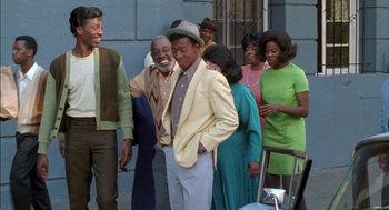 Movie still from “The Five Heartbeats” (1991), directed by Robert Townsend – A group of men and women standing next to each other; Medium shot, High angle