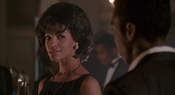 Movie still from “The Five Heartbeats” (1991), directed by Robert Townsend – A woman in a black dress and a man in a black suit; Close Up shot, Over the shoulder angle