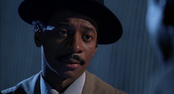 Movie still from “The Five Heartbeats” (1991), directed by Robert Townsend – A person wearing a suit and a hat; Close Up shot, Low angle