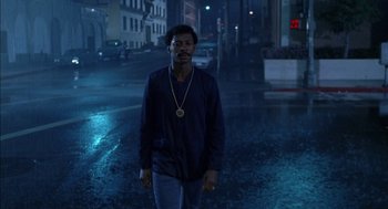 Movie still from “The Five Heartbeats” (1991), directed by Robert Townsend – A man standing in the middle of the street at night; Medium shot, Low angle