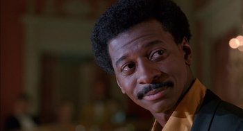 Movie still from “The Five Heartbeats” (1991), directed by Robert Townsend – A man's face in a yellow shirt; Close Up shot, Low angle