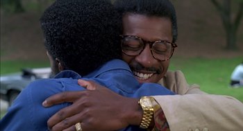 Movie still from “The Five Heartbeats” (1991), directed by Robert Townsend – A man hugging another man in a park; Close Up shot, Over the shoulder angle
