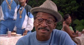 Movie still from “The Five Heartbeats” (1991), directed by Robert Townsend – A person wearing glasses and a hat; Close Up shot, High angle