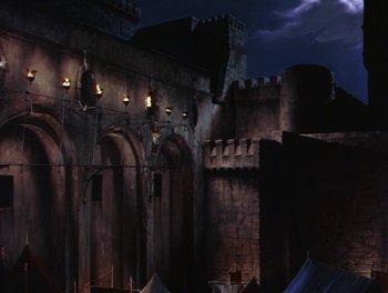 Movie still from “The Flame and the Arrow” (1950), directed by Jacques Tourneur – A castle with a dark sky in the background; Extreme Wide shot, Low angle