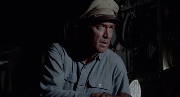 Movie still from “The Flight of the Phoenix” (1965), directed by Robert Aldrich – A person wearing a hat; Close Up shot, Low angle