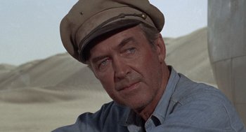 Movie still from “The Flight of the Phoenix” (1965), directed by Robert Aldrich – A person wearing a hat; Close Up shot, Low angle