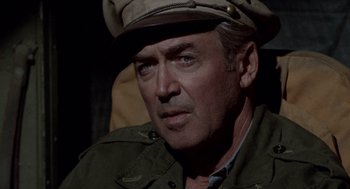 Movie still from “The Flight of the Phoenix” (1965), directed by Robert Aldrich – A person wearing a hat; Close Up shot, Over the shoulder angle