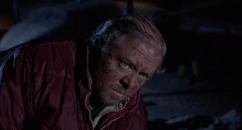 Movie still from “The Flight of the Phoenix” (1965), directed by Robert Aldrich – A person wearing a red jacket; Close Up shot, High angle