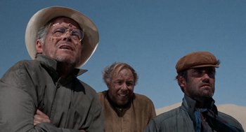 Movie still from “The Flight of the Phoenix” (1965), directed by Robert Aldrich – A group of men standing next to each other; Close Up shot, Low angle