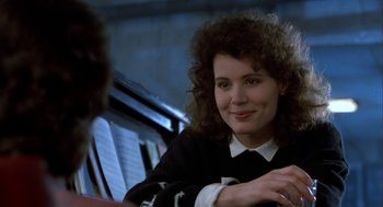 Movie still from “The Fly” (1986), directed by David Cronenberg – A person sitting at a table; Close Up shot, Over the shoulder angle