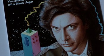 Movie still from “The Fly” (1986), directed by David Cronenberg – A painting of a person; Close Up shot, Overhead angle