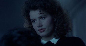 Movie still from “The Fly” (1986), directed by David Cronenberg – A person with curly hair; Close Up shot, Over the shoulder angle