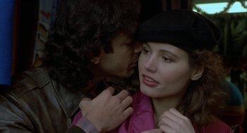 Movie still from “The Fly” (1986), directed by David Cronenberg – A man kissing a woman on the cheek; Close Up shot, Over the shoulder angle