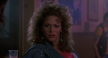 Movie still from “The Fly” (1986), directed by David Cronenberg – A person wearing a jean jacket; Close Up shot, Low angle