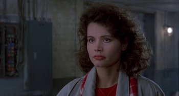 Movie still from “The Fly” (1986), directed by David Cronenberg – A person wearing a red shirt; Close Up shot, Over the shoulder angle