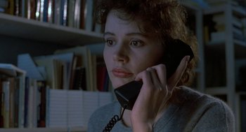 Movie still from “The Fly” (1986), directed by David Cronenberg – A woman holding a phone up to her ear; Close Up shot, High angle