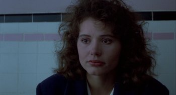Movie still from “The Fly” (1986), directed by David Cronenberg – A person with curly hair; Close Up shot, Over the shoulder angle