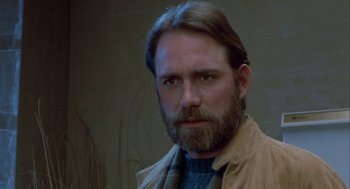 Movie still from “The Fly” (1986), directed by David Cronenberg – A person with a beard; Close Up shot, Low angle