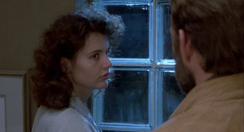 Movie still from “The Fly” (1986), directed by David Cronenberg – A woman looking at a man in front of a window; Close Up shot, Over the shoulder angle