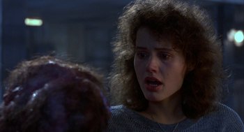 Movie still from “The Fly” (1986), directed by David Cronenberg – A young woman is crying while talking to another woman; Close Up shot, Over the shoulder angle