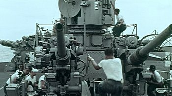 Movie still from “The Fog of War” (2003), directed by Errol Morris – Men working on an old steam engine; Wide shot, Low angle