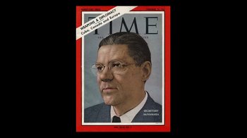 Movie still from “The Fog of War” (2003), directed by Errol Morris – An old time magazine cover with a man wearing glasses; Close Up shot, Overhead angle