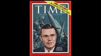 Movie still from “The Fog of War” (2003), directed by Errol Morris – A time magazine cover with a painting of a man in the background; Close Up shot, Overhead angle