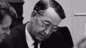 Movie still from “The Fog of War” (2003), directed by Errol Morris – An old black and white photo of a man in a suit; Close Up shot, Over the shoulder angle