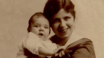 Movie still from “The Fog of War” (2003), directed by Errol Morris – An old photograph of a woman holding a baby; Extreme Close Up shot, Overhead angle