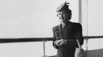Movie still from “The Fog of War” (2003), directed by Errol Morris – An old black and white photo of a woman wearing a hat; Medium shot, Low angle