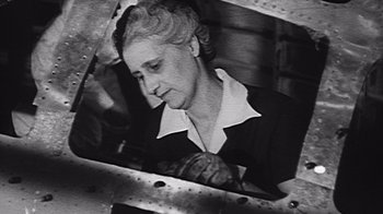Movie still from “The Fog of War” (2003), directed by Errol Morris – An old black and white photo of a woman; Close Up shot, Low angle