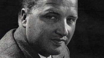 Movie still from “The Fog of War” (2003), directed by Errol Morris – An old black and white photo of a man in a suit; Extreme Close Up shot, Low angle