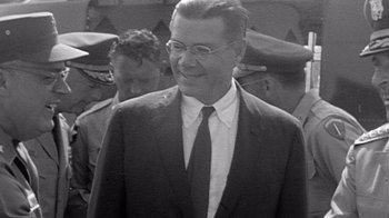 Movie still from “The Fog of War” (2003), directed by Errol Morris – An older man in a suit and tie; Close Up shot, Over the shoulder angle