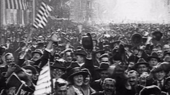 Movie still from “The Fog of War” (2003), directed by Errol Morris – An old photo of a crowd of people wearing hats; Medium shot, High angle