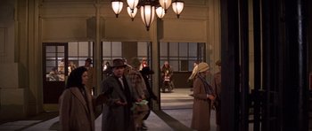 Movie still from “The Fortune” (1975), directed by Mike Nichols – A group of people dressed in vintage clothing; Wide shot, High angle