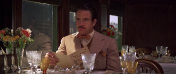 Movie still from “The Fortune” (1975), directed by Mike Nichols – A man sitting at a dinner table reading a menu; Close Up shot, Over the shoulder angle