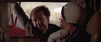 Movie still from “The Fortune” (1975), directed by Mike Nichols – An older man looking in a mirror while a younger man looks on; Close Up shot, Over the shoulder angle