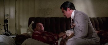 Movie still from “The Fortune” (1975), directed by Mike Nichols – A man in a hospital bed talking to another man in a hospital bed; Medium shot, Over the shoulder angle